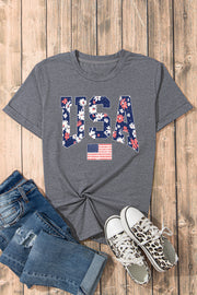 a t - shirt with the american flag on it next to a pair of jeans