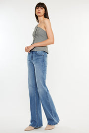 a woman in a gray tank top and blue jeans