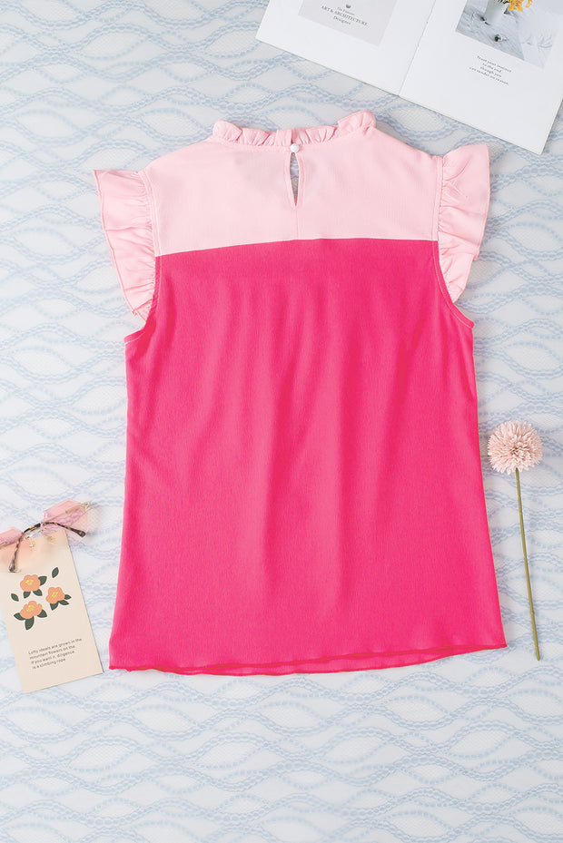 a pink top with ruffles on a bed