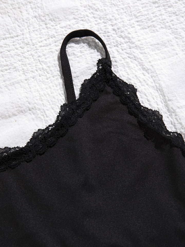 a black bra that is laying on a bed