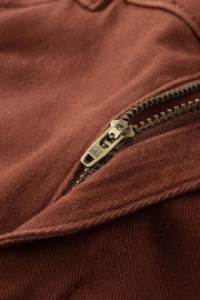 a close up of a zipper on a brown shirt