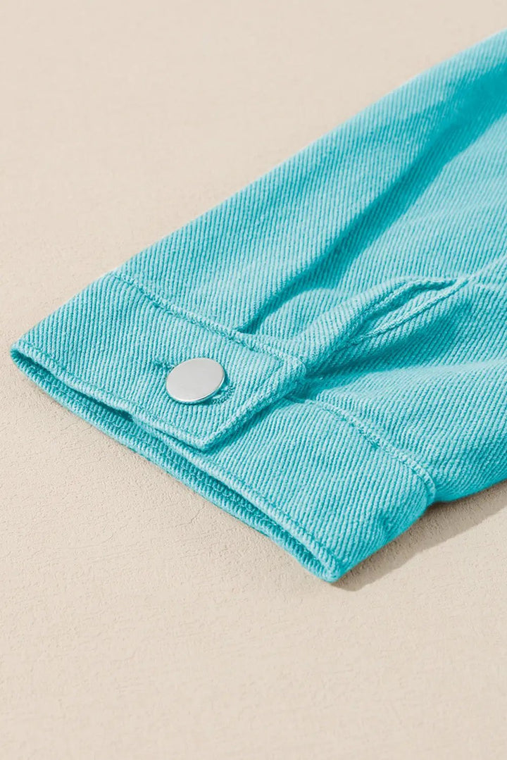 a close up of a button on a blue shirt