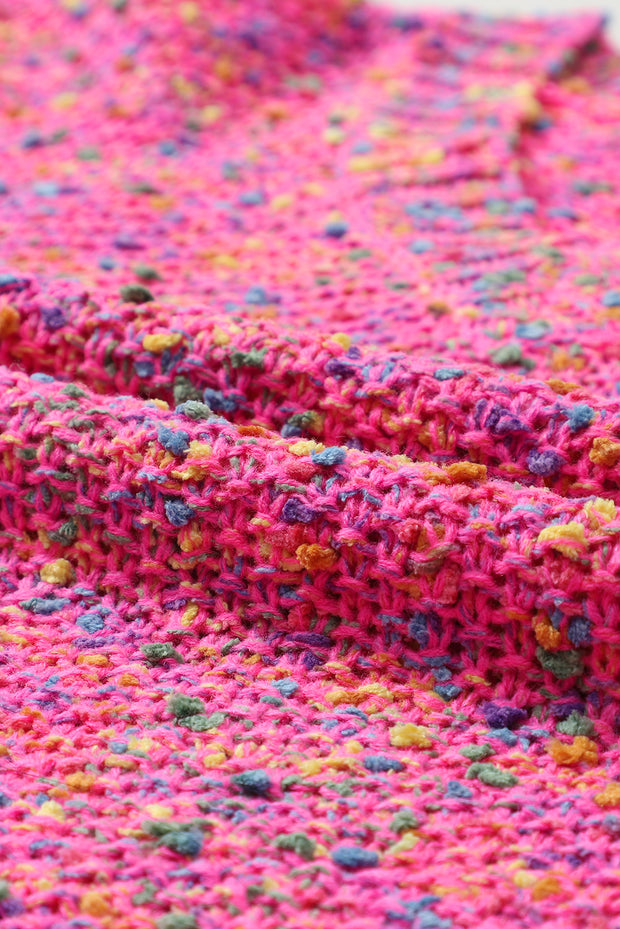 a crocheted blanket is laying on a table