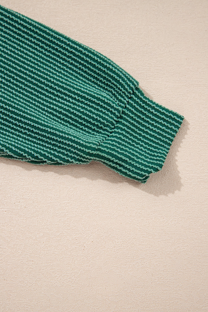 Sleeve cuff detail of green Evergreen JOLLY Corded Top. Ribbed texture adds style and warmth from Faith & Co. Boutique.