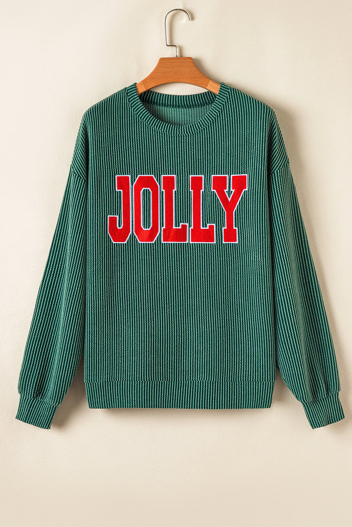 Flat lay of green Evergreen JOLLY Corded Long Sleeve Top with red lettering. Shop festive tops at Faith & Co. Boutique.