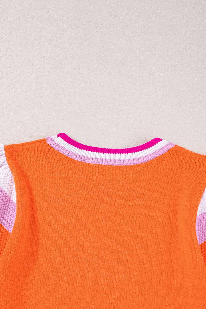 an orange top with pink and white stripes