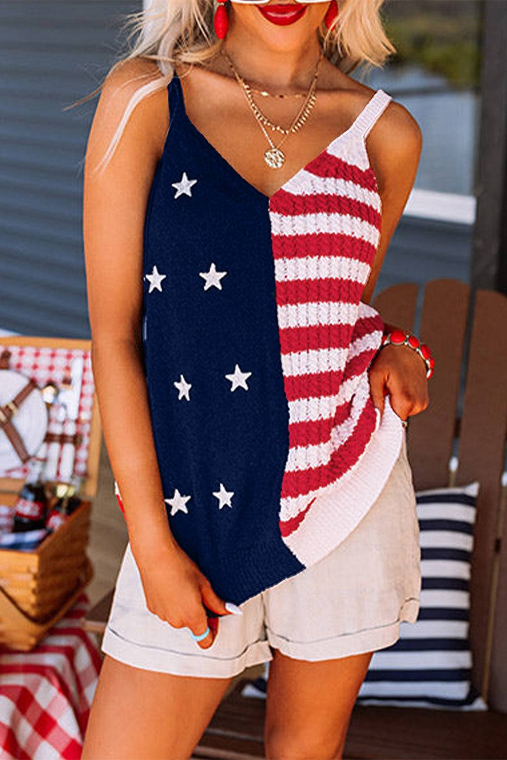 a woman wearing a patriotic top and shorts