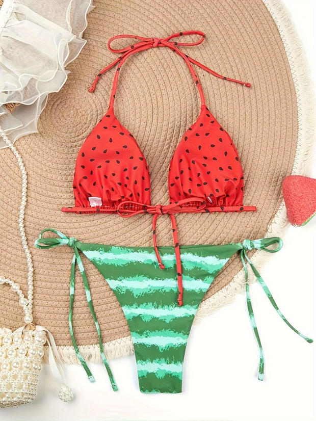 a bikini top and a bikini bottom on a beach mat