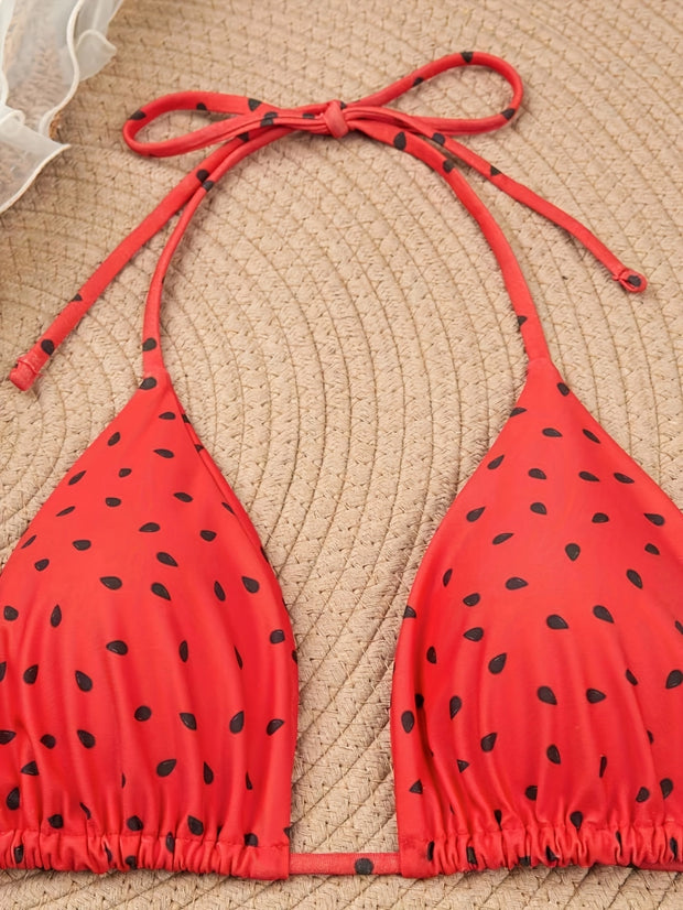 a red bikini top with black polka dots on it