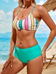 a woman in a bikini standing on a beach