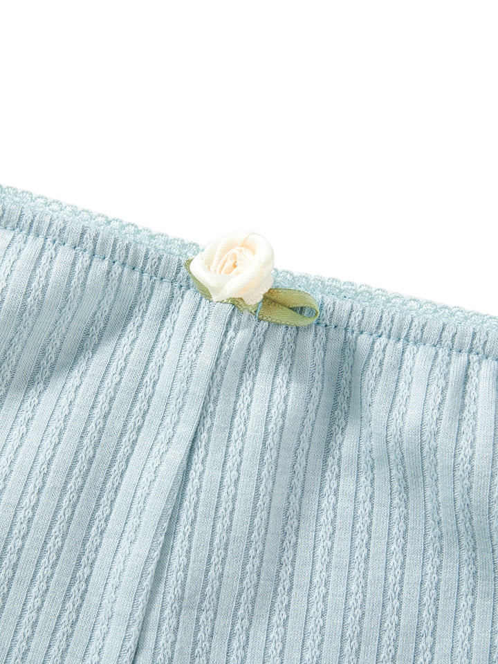 a white flower sticking out of the side of a blue shirt