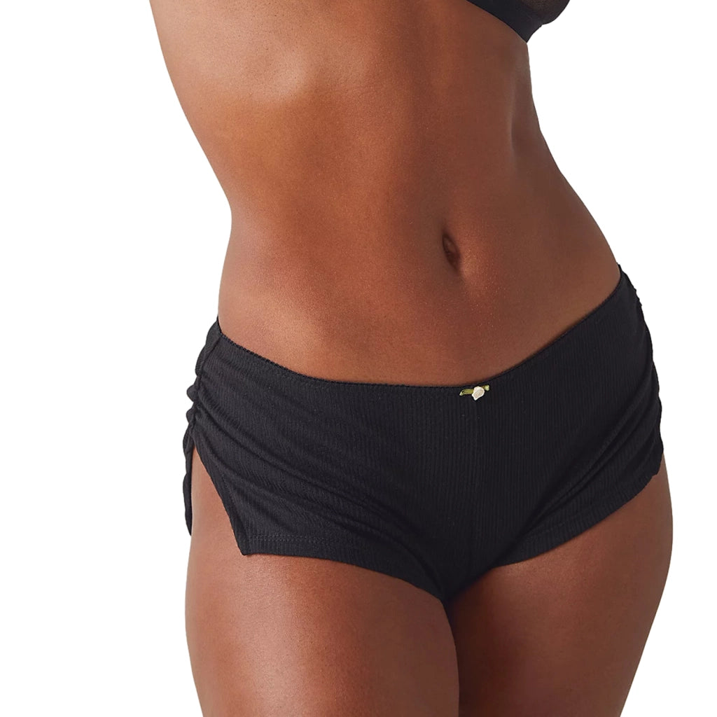 a woman in a black bikini top and panties