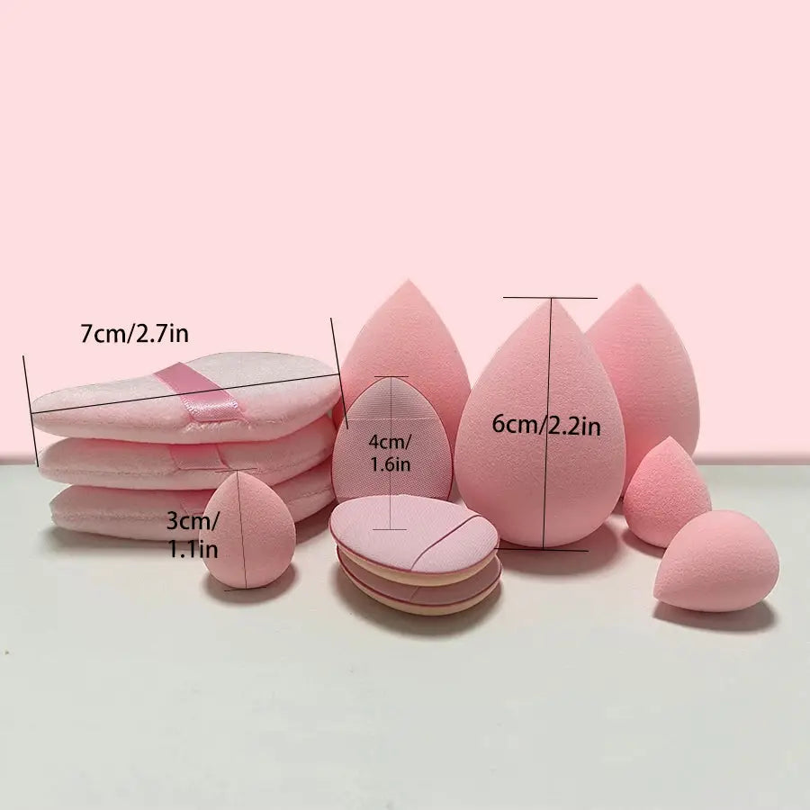 a pile of pink makeup sponges sitting on top of a table