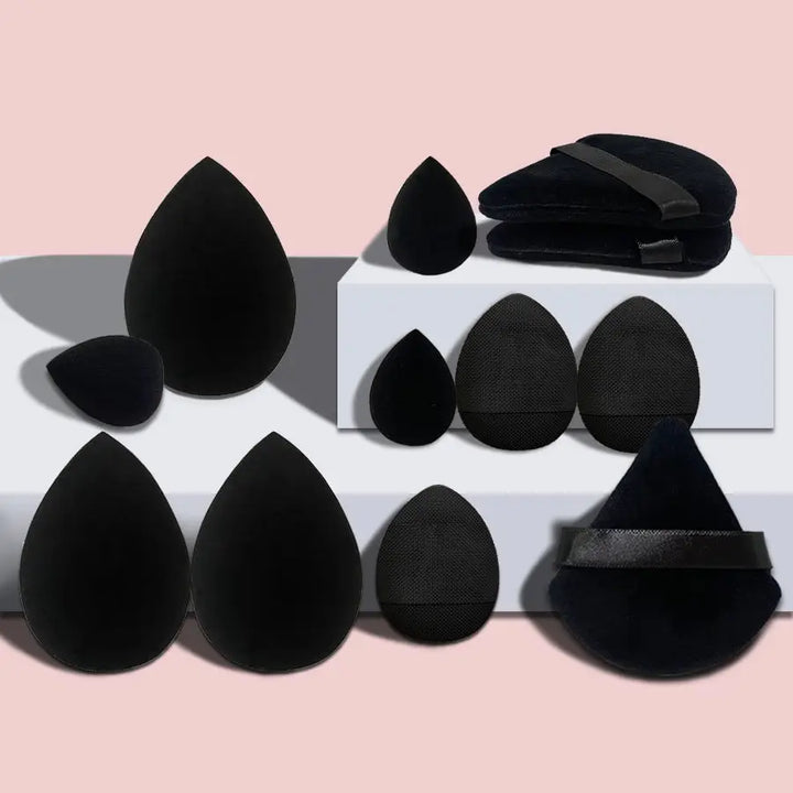 a group of black objects sitting on top of a white shelf