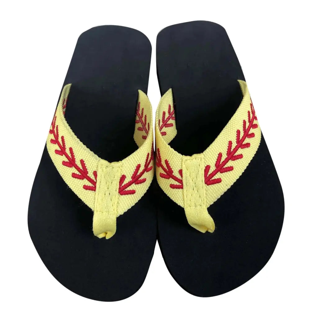 a pair of black and yellow sandals with red stitches
