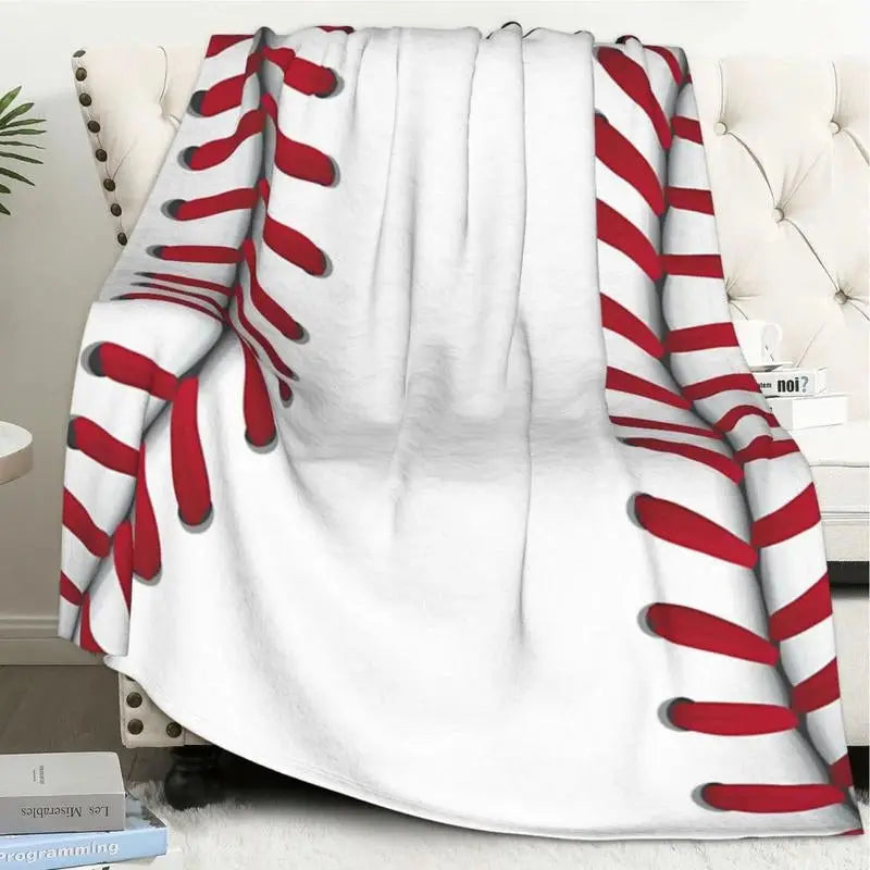 a white chair with a red and white baseball blanket on top of it