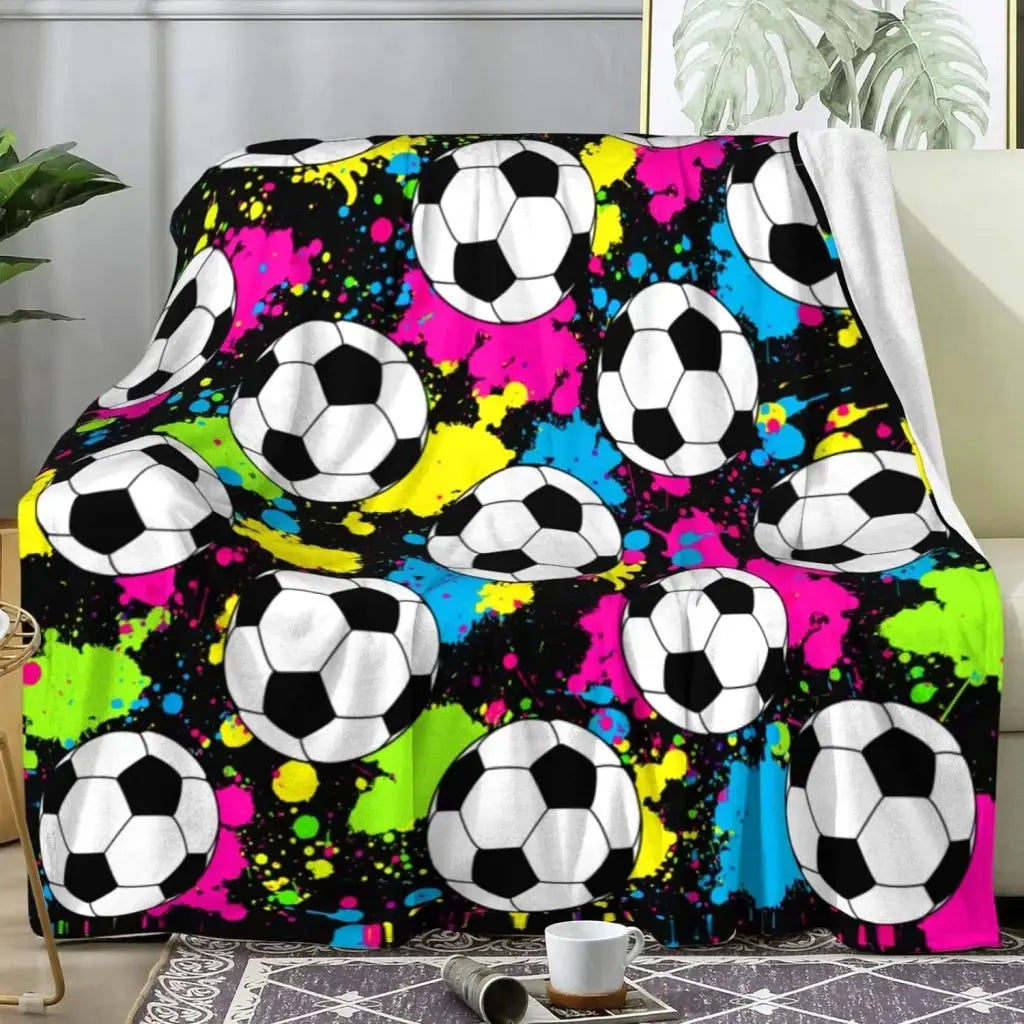 a couch covered in a soccer themed blanket