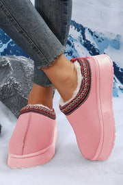 a close up of a person wearing pink slippers