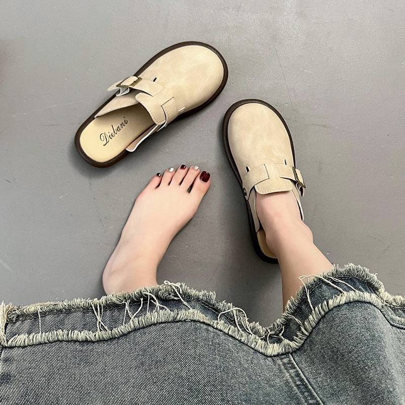 a woman's feet in a pair of beige shoes