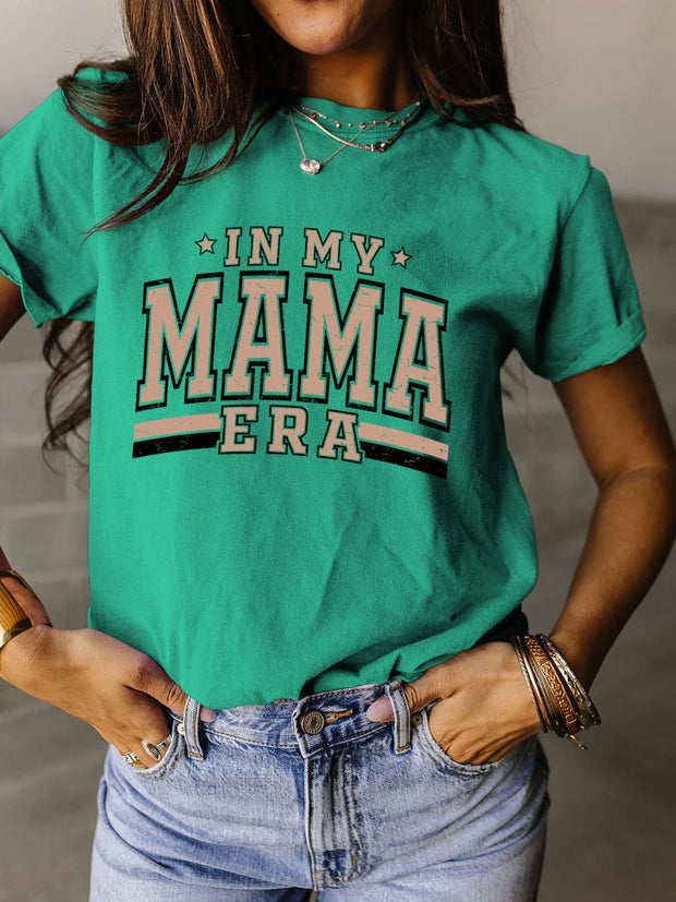 a woman wearing a green shirt that says in my mama era