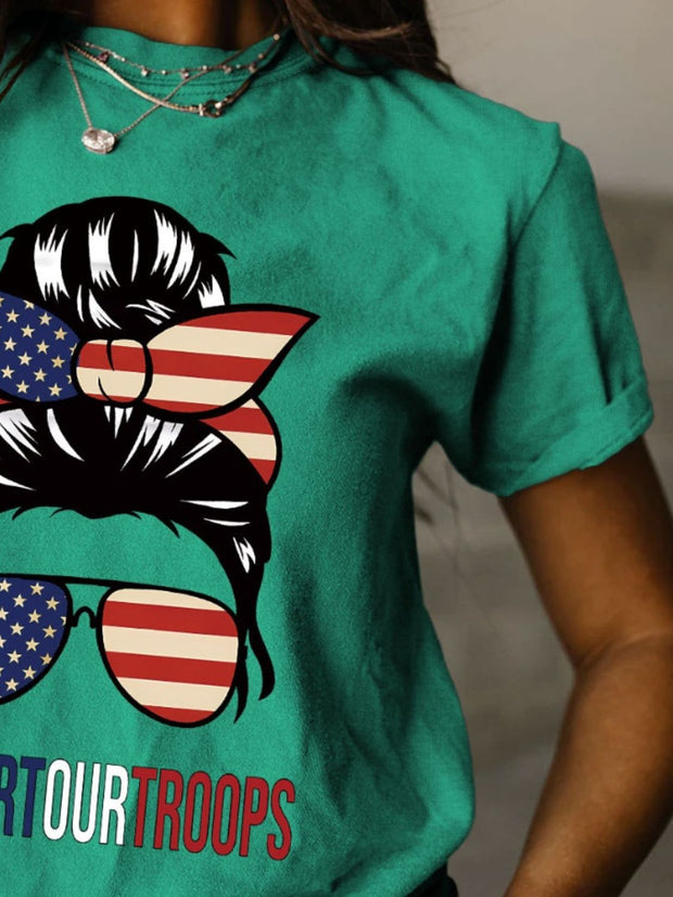 a woman wearing a green t - shirt with an american flag on it