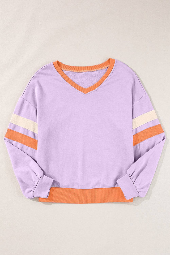 a purple shirt with orange and white stripes