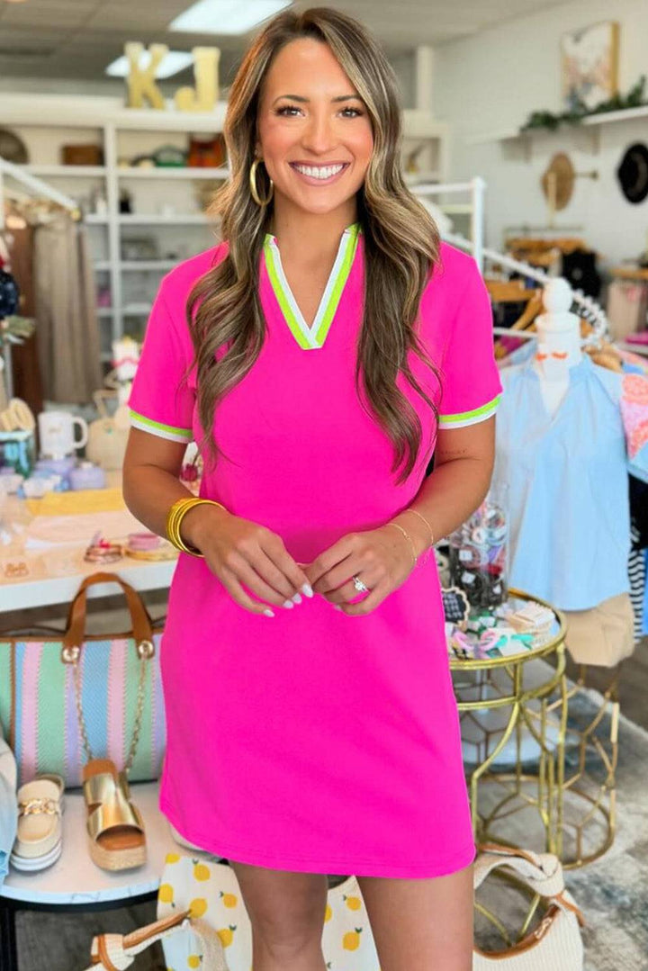 a woman in a pink dress standing in a store