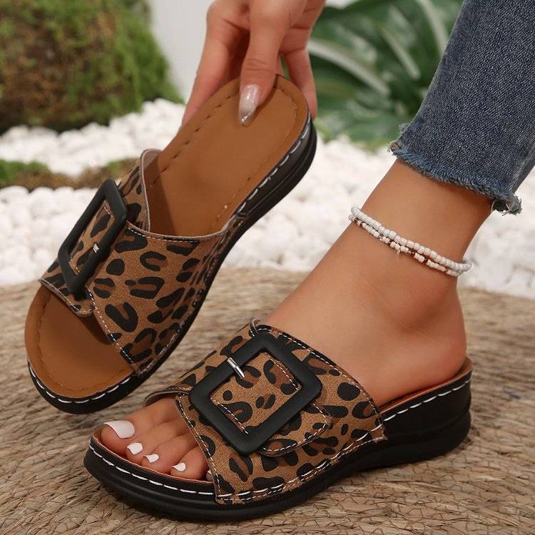 a close up of a person wearing a leopard print sandal