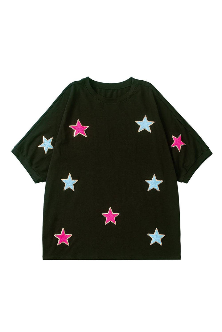 a black t - shirt with pink and blue stars on it