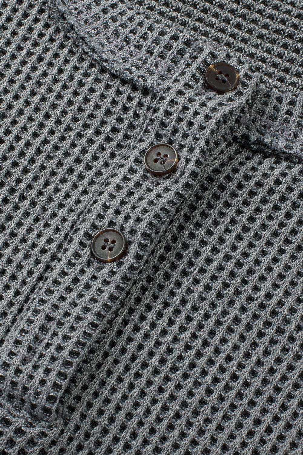 a close up of a shirt with buttons on it