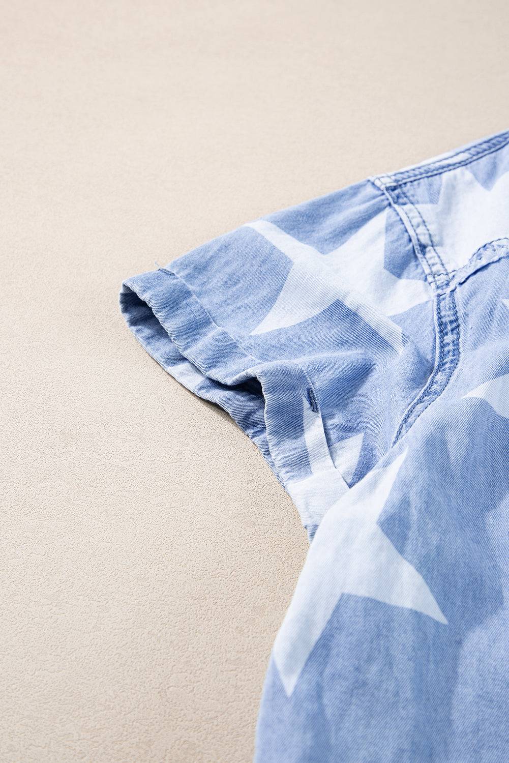 a blue and white shirt laying on top of a floor