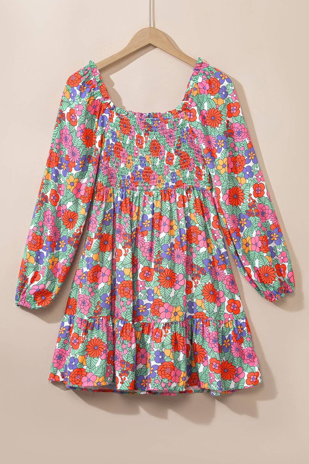 a colorful floral dress hanging on a hanger