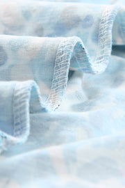 a close up of a blue fabric with white flowers on it