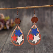 a pair of wooden earrings with red, white and blue stars