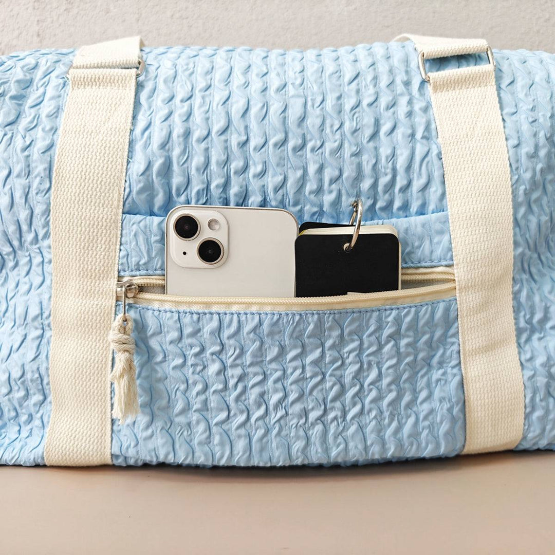 a blue bag with a cell phone in it