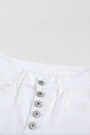 a pair of white jeans with buttons on them