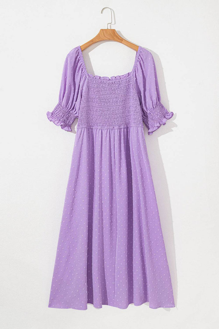 Back view of Wisteria Swiss Dot Smocked Frilled Neckline Plus Size Dress on hanger, highlighting smocked bodice and elegant silhouette.