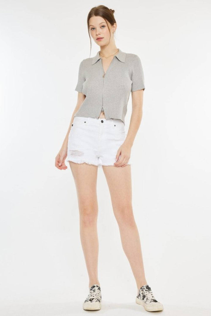 a woman wearing white shorts and a gray shirt
