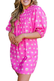 a woman in a pink polka dot dress