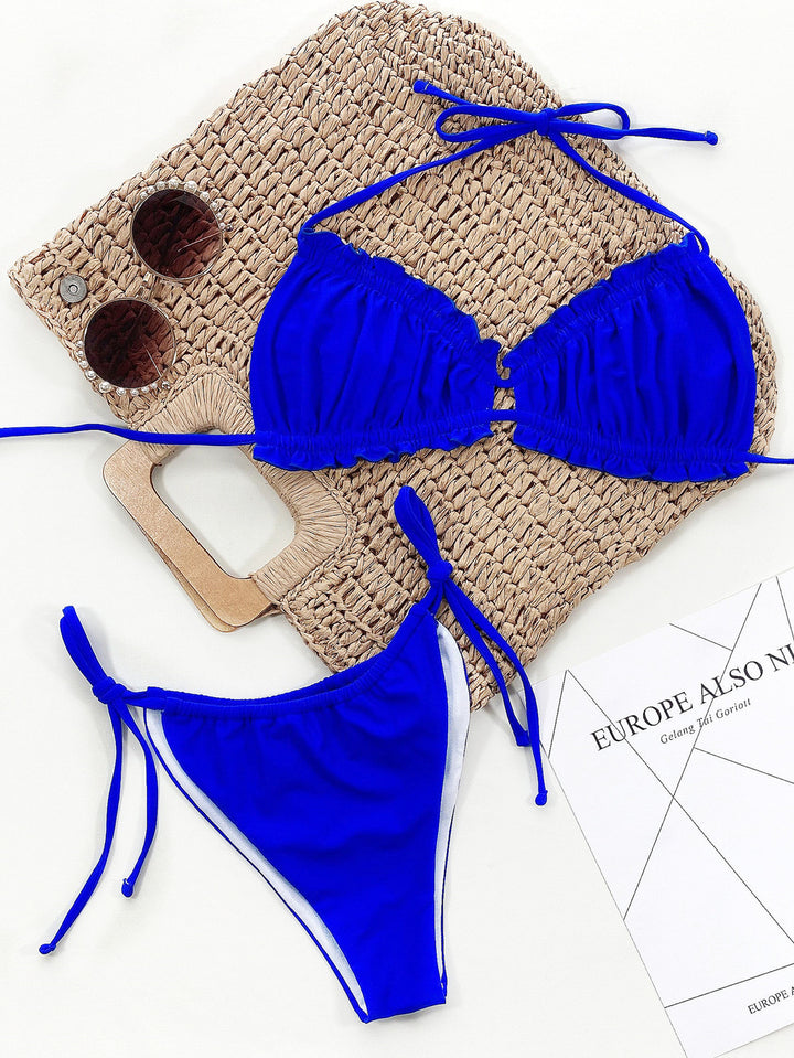 a blue bikini top and a pair of sunglasses