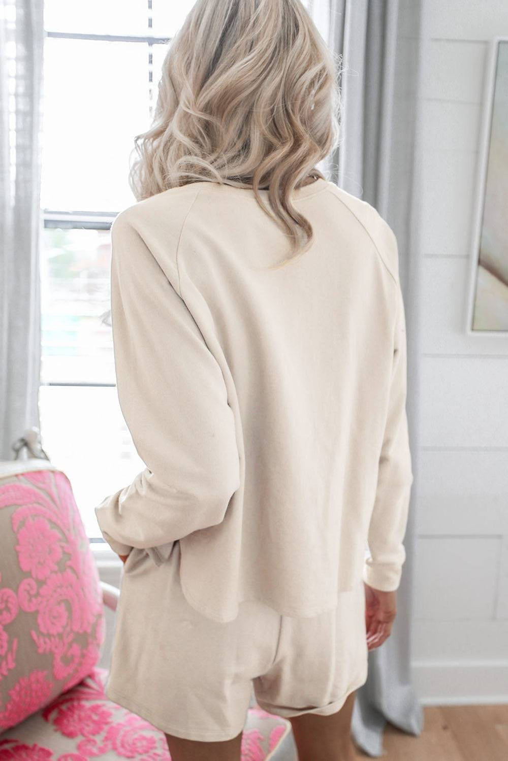 a woman standing in front of a window