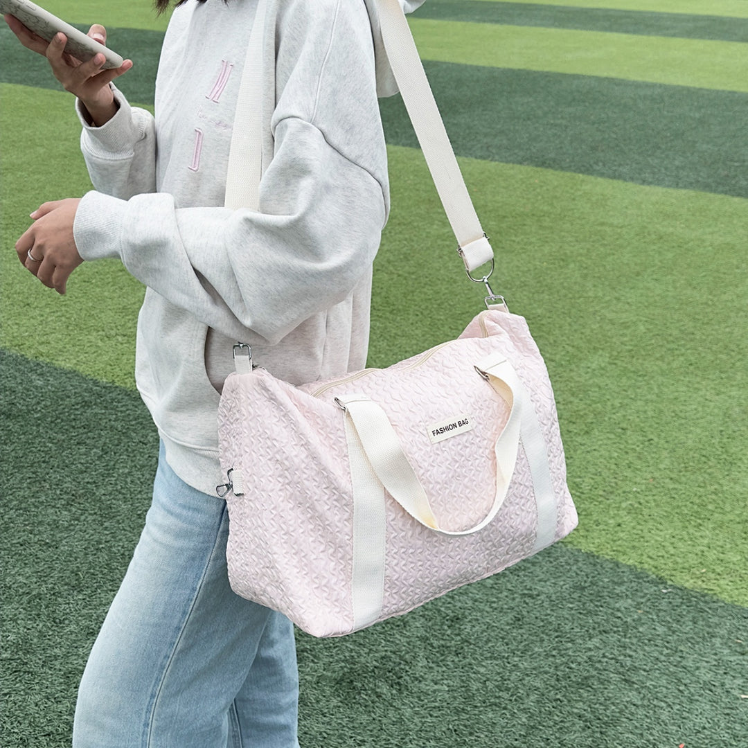 a woman holding a pink purse and a cell phone