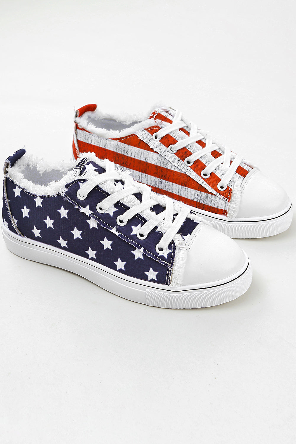 a pair of white and red sneakers with stars on them