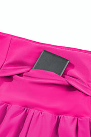 a pink dress with a black square object in the middle of it