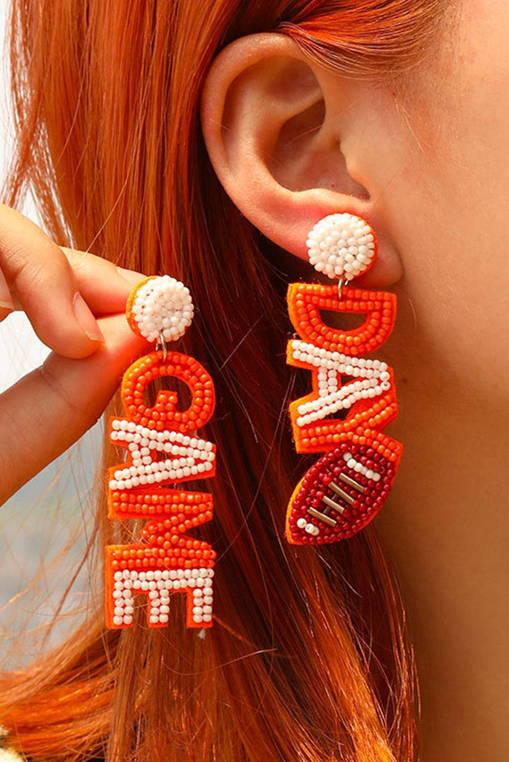 a close up of a person wearing a pair of earrings