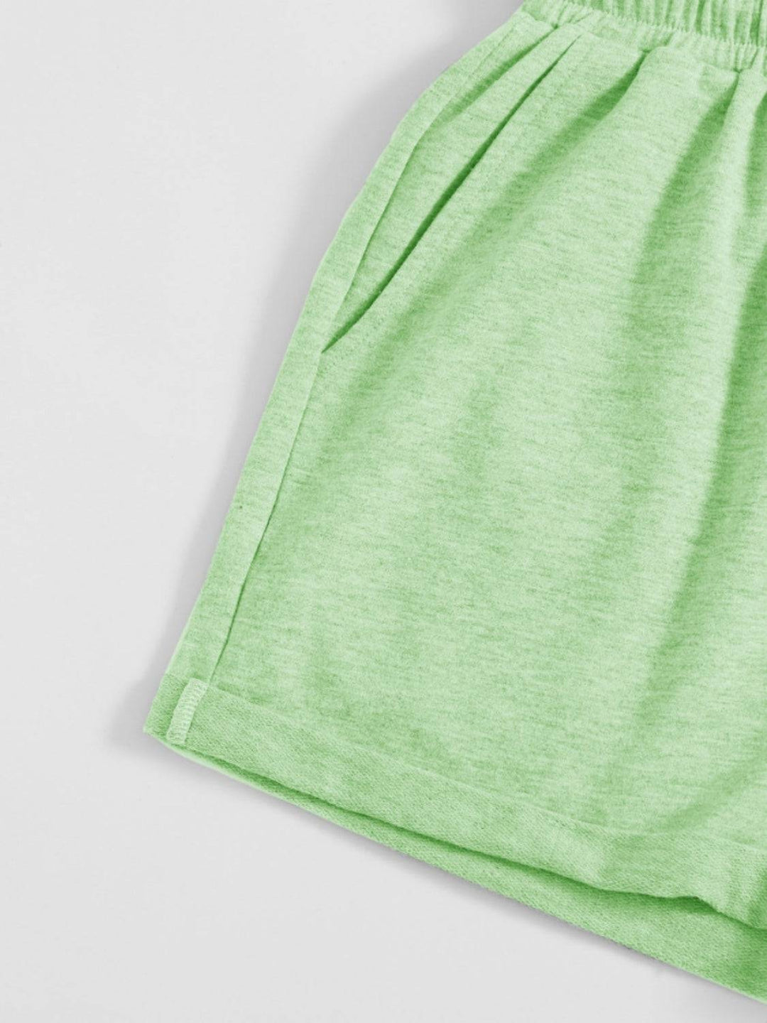 a close up of a green shorts on a white surface