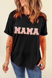a woman wearing a black shirt with the word mama printed on it