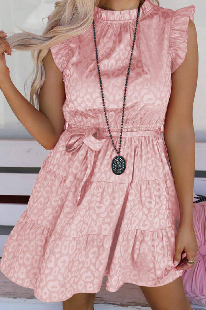 a woman with blonde hair wearing a pink dress