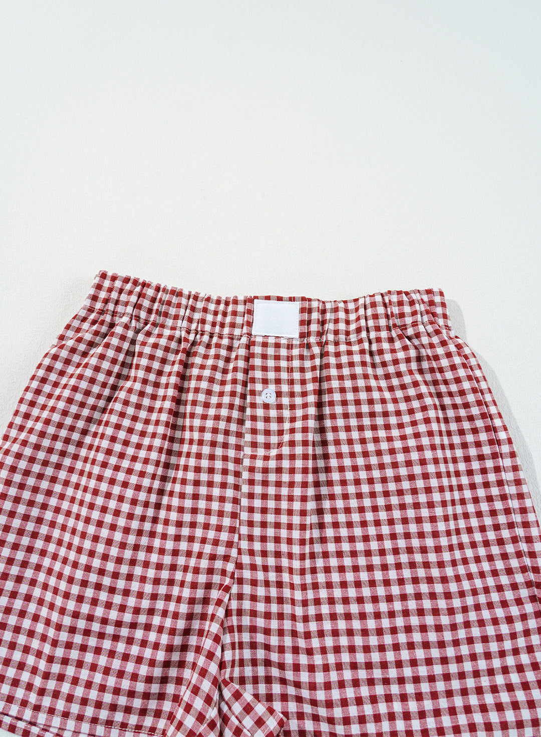 Top section of Red Plaid Gingham Printed High Waist Shorts showing elastic waist and pleated design. Perfect for daily summer outfits at Faith & Co. Boutique.
