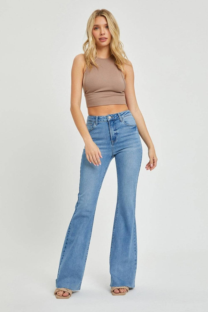 a woman in high rise jeans and a crop top